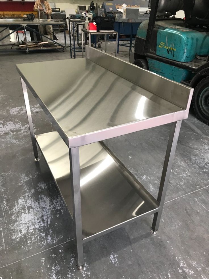 Long stainless bench with upstand and undershelf, ready to leave the workshop